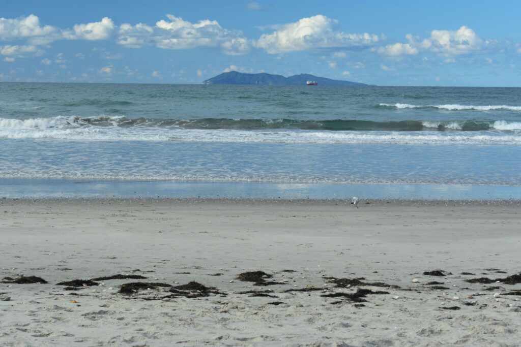 Waihi Beach in one of its many moods, setting the scene for Maui Catches the Big Kahuna